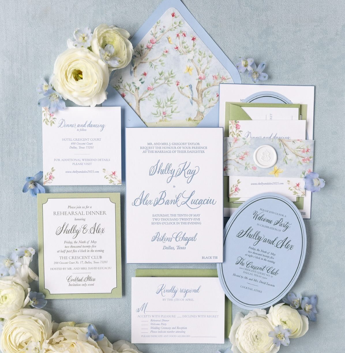 Wedding stationery set with floral invitations, envelopes, and RSVP cards with white flowers.