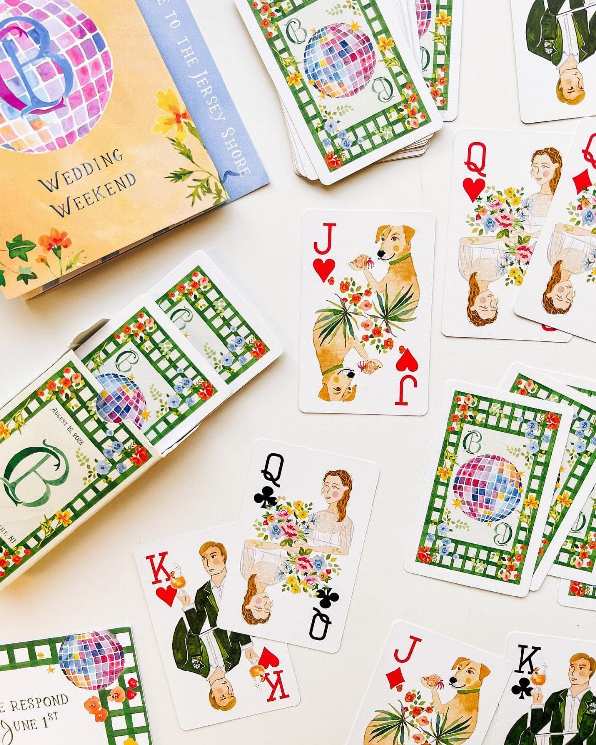 Custom wedding playing cards and invitation booklet featuring colorful illustrations of a couple.