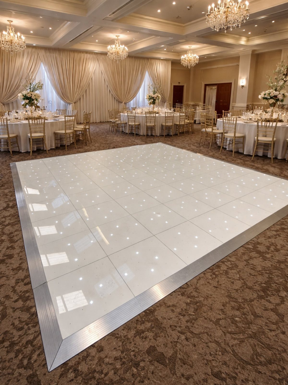 White LED illuminated dance floor in a formal wedding reception ballroom setting