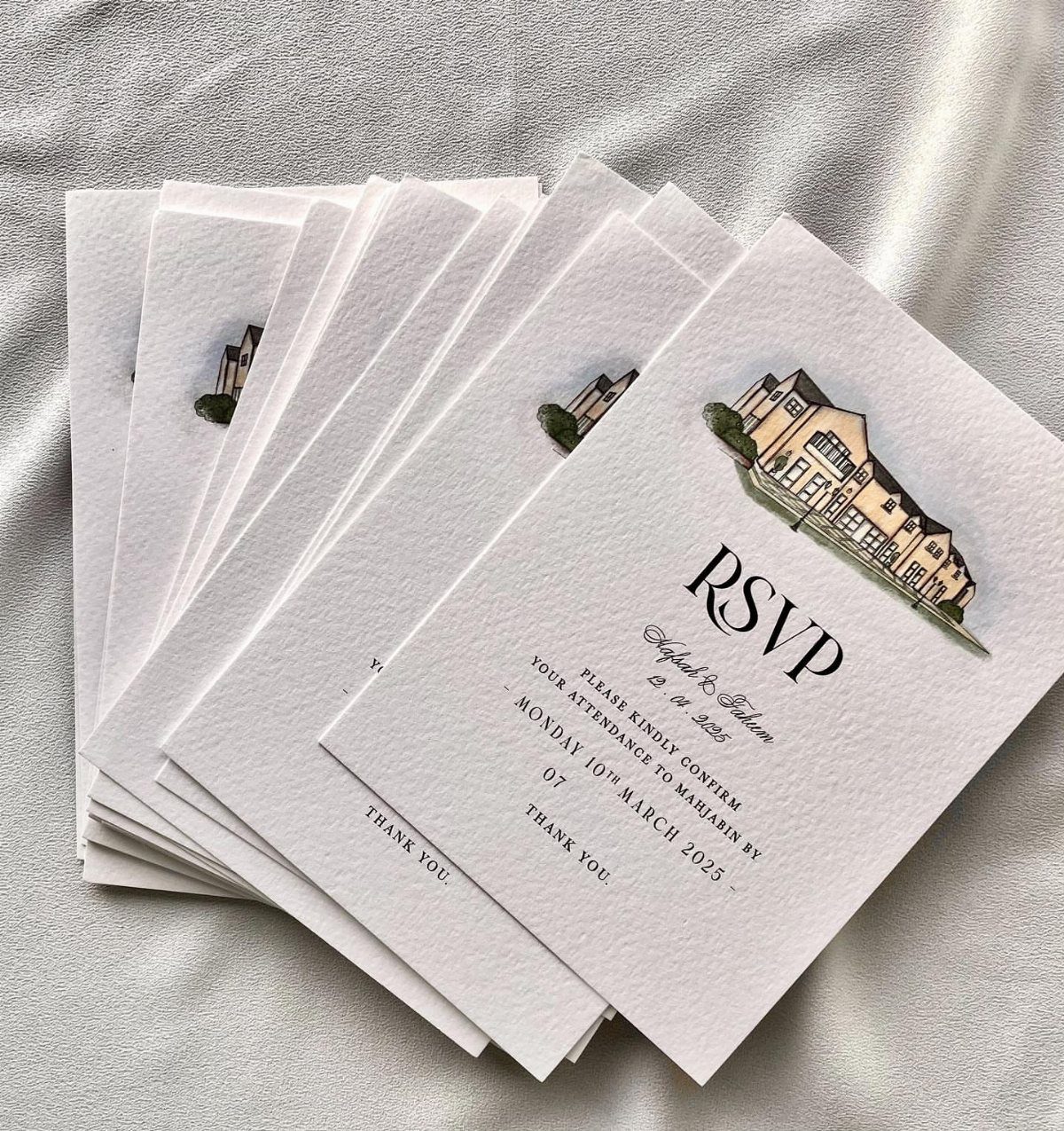 Stack of white RSVP cards with a house illustration and elegant black text.