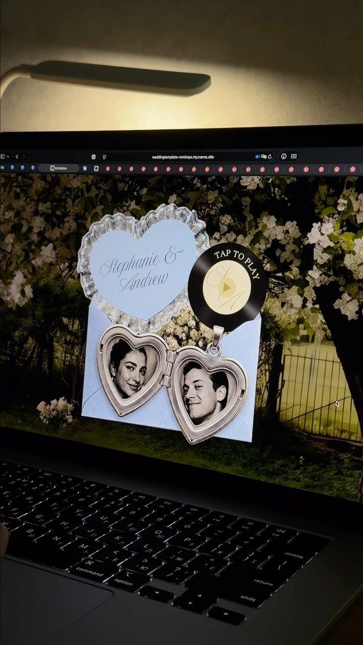 Digital wedding invitation template on a laptop screen featuring heart-shaped photo frames.