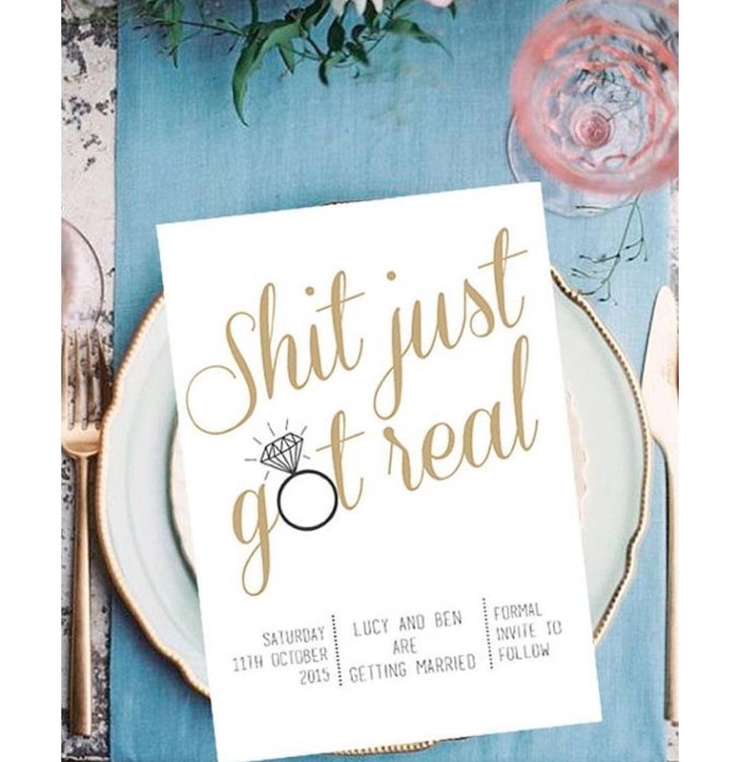 Wedding invitation card with humorous gold text resting on a blue dinner plate.