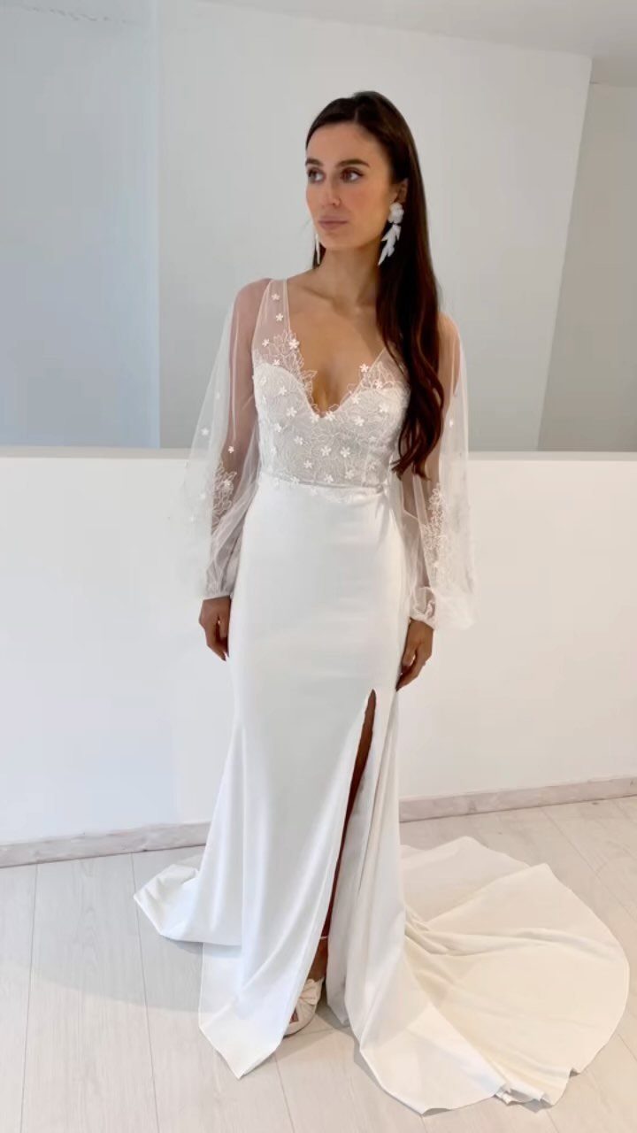 Woman in white wedding dress with voluminous balloon sleeves and lace bodice.