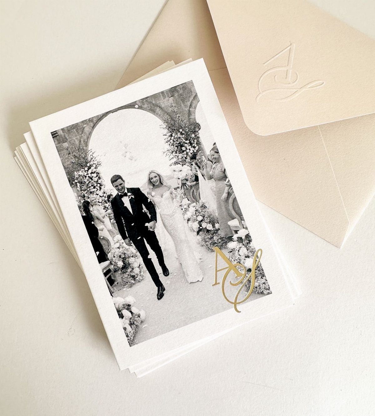 Monogrammed thank you cards with a wedding photo and a matching embossed envelope.