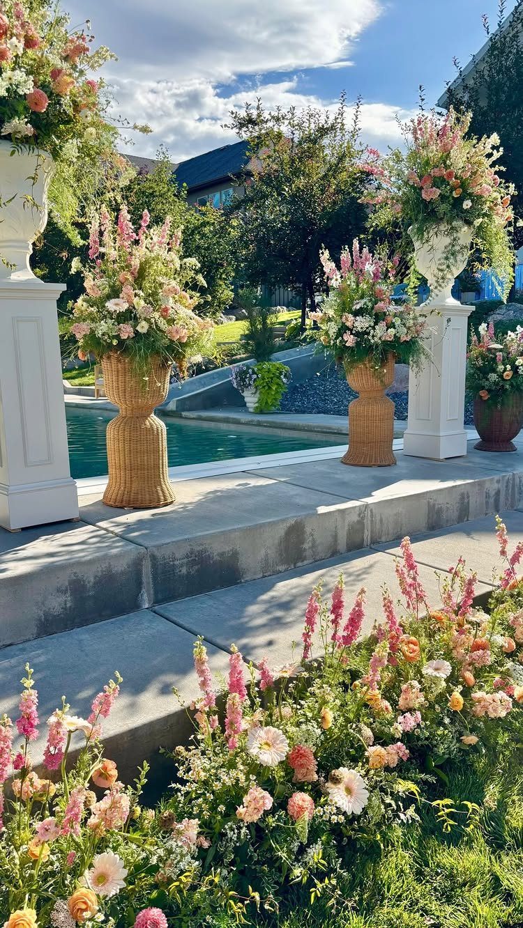 Floral arrangements and a swimming pool in a decorated residential backyard setting.