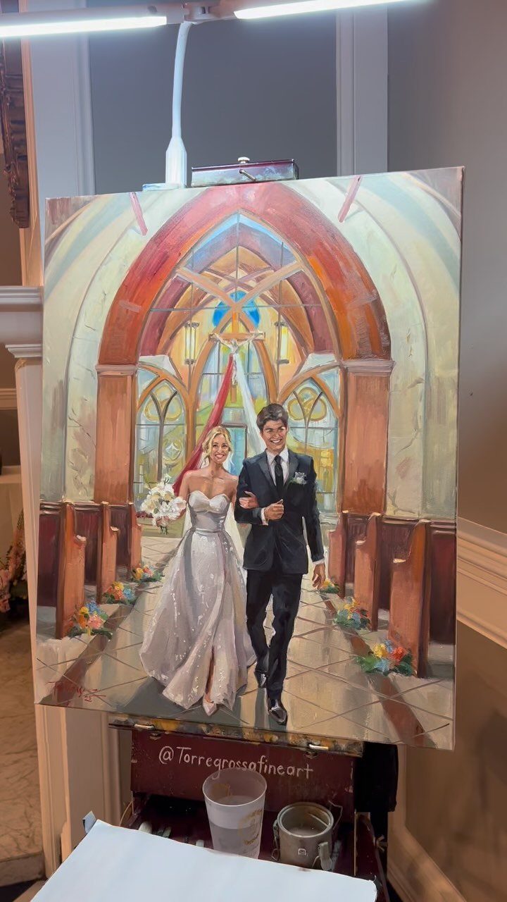 Painting of a wedding couple walking down a church aisle on an easel