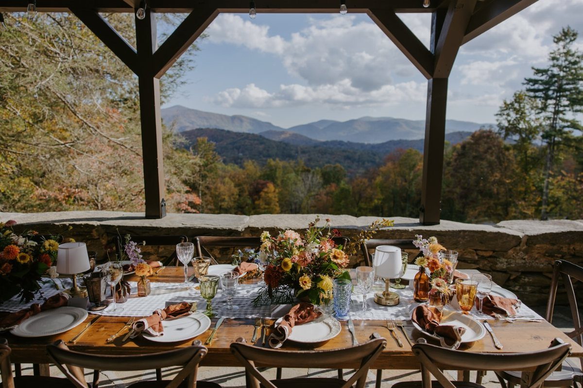 Wedding table setting under a pavilion overlooking the Blue Ridge Mountains in autumn