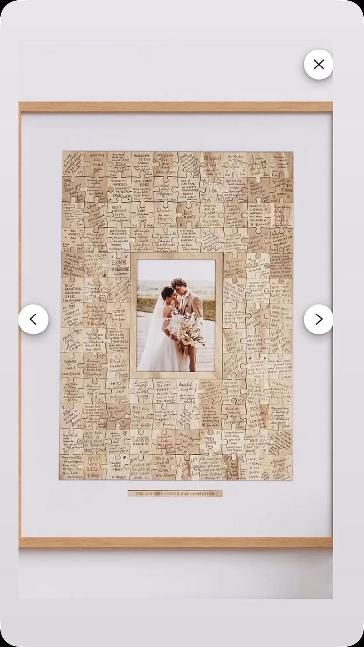 Framed jigsaw puzzle guest book with handwritten messages surrounding a wedding couple photo.