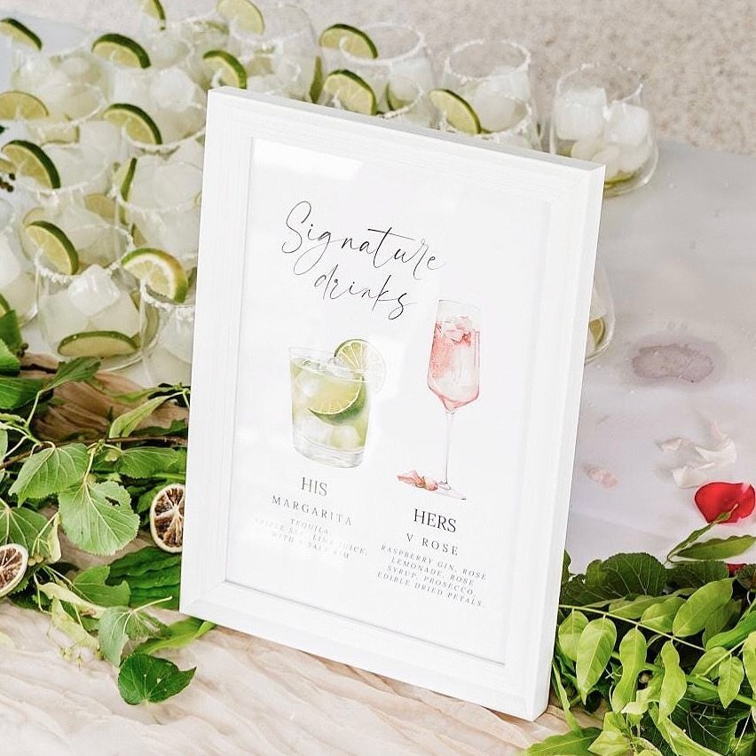Signature drinks sign with margarita and rose illustrations surrounded by lime-filled glasses.