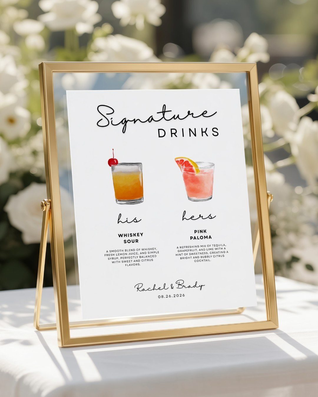 Signature drinks sign in gold frame showing whiskey sour and pink paloma illustrations.