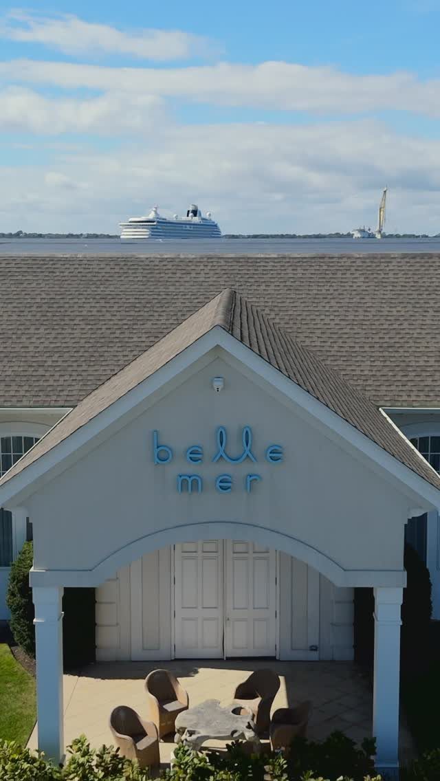 Belle Mer venue building with coastal views and a cruise ship in the distance