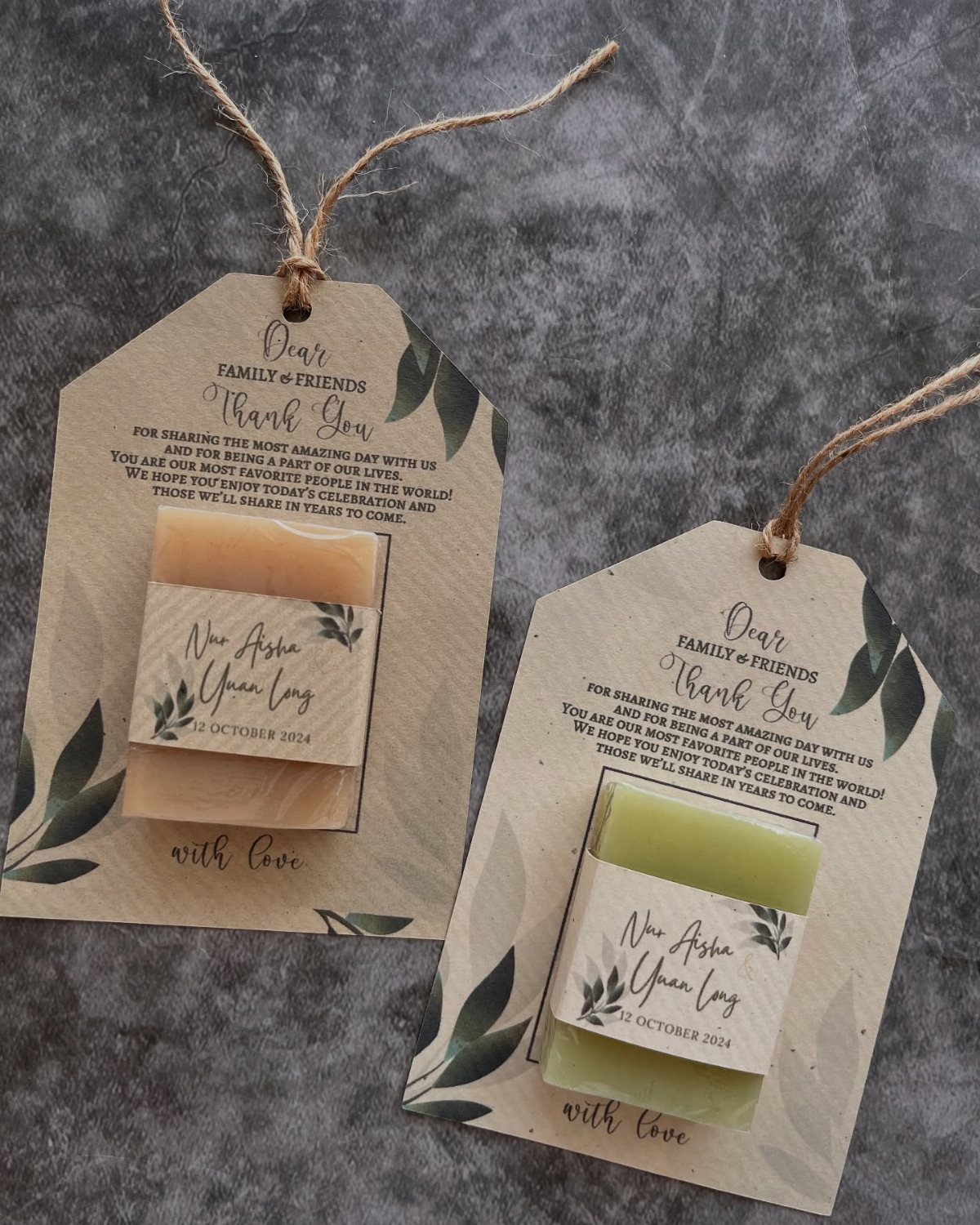 Handmade soap bars attached to brown kraft paper tags with twine and leaf prints.