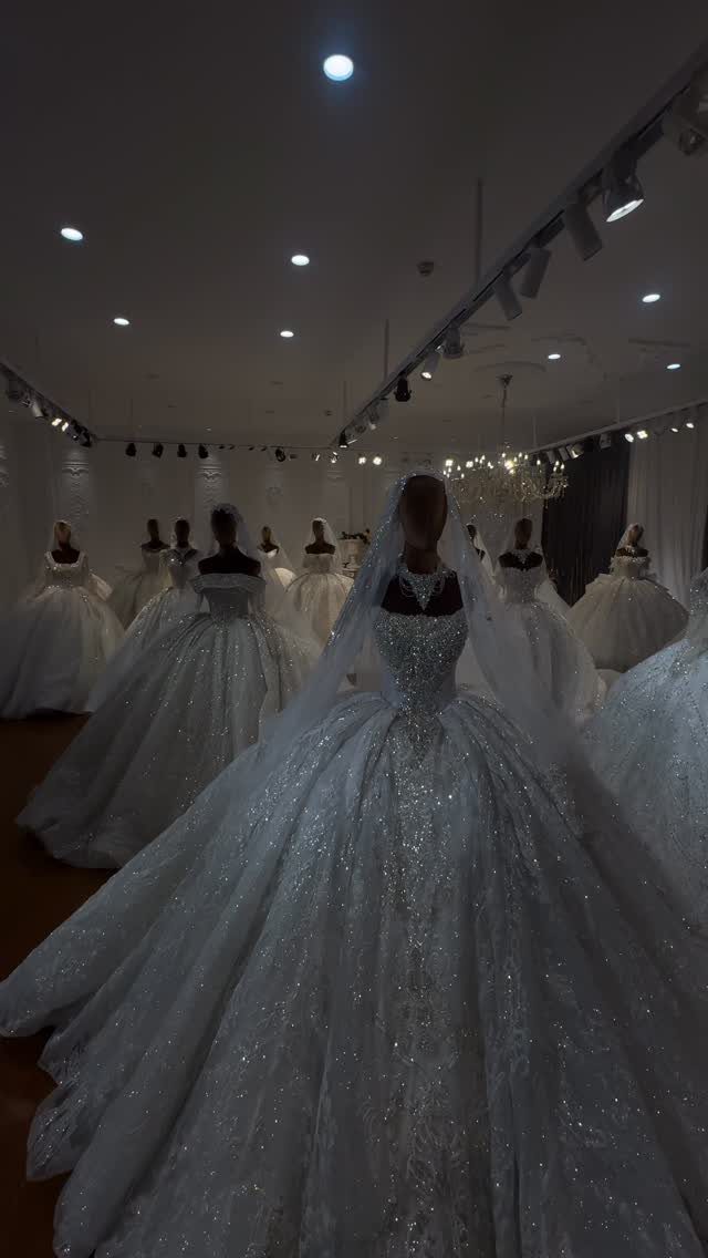 Sparkly white wedding ballgown with shimmering sequins on a mannequin in a showroom
