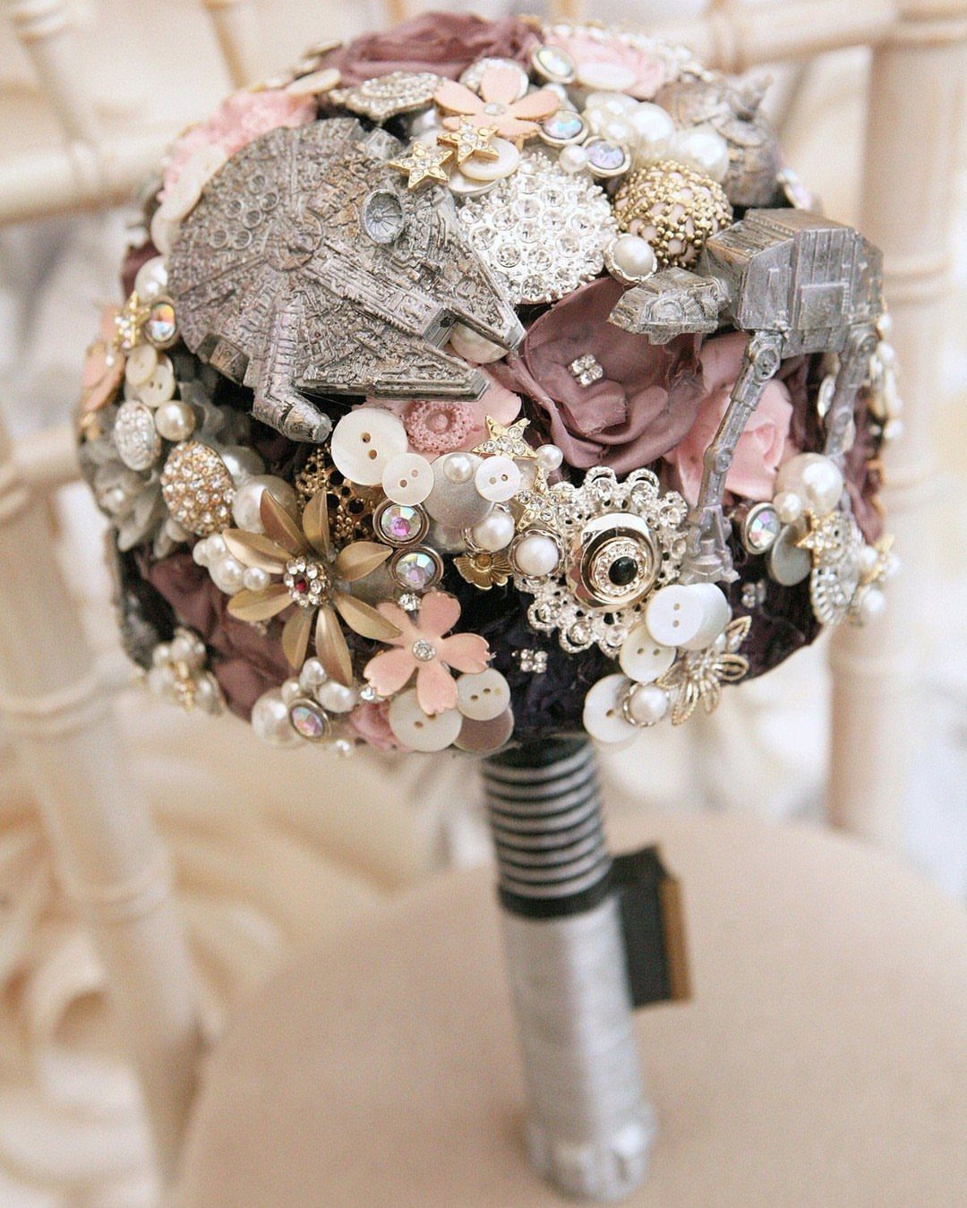 Star Wars themed bridal bouquet with Millennium Falcon and AT-AT miniatures among pearls.