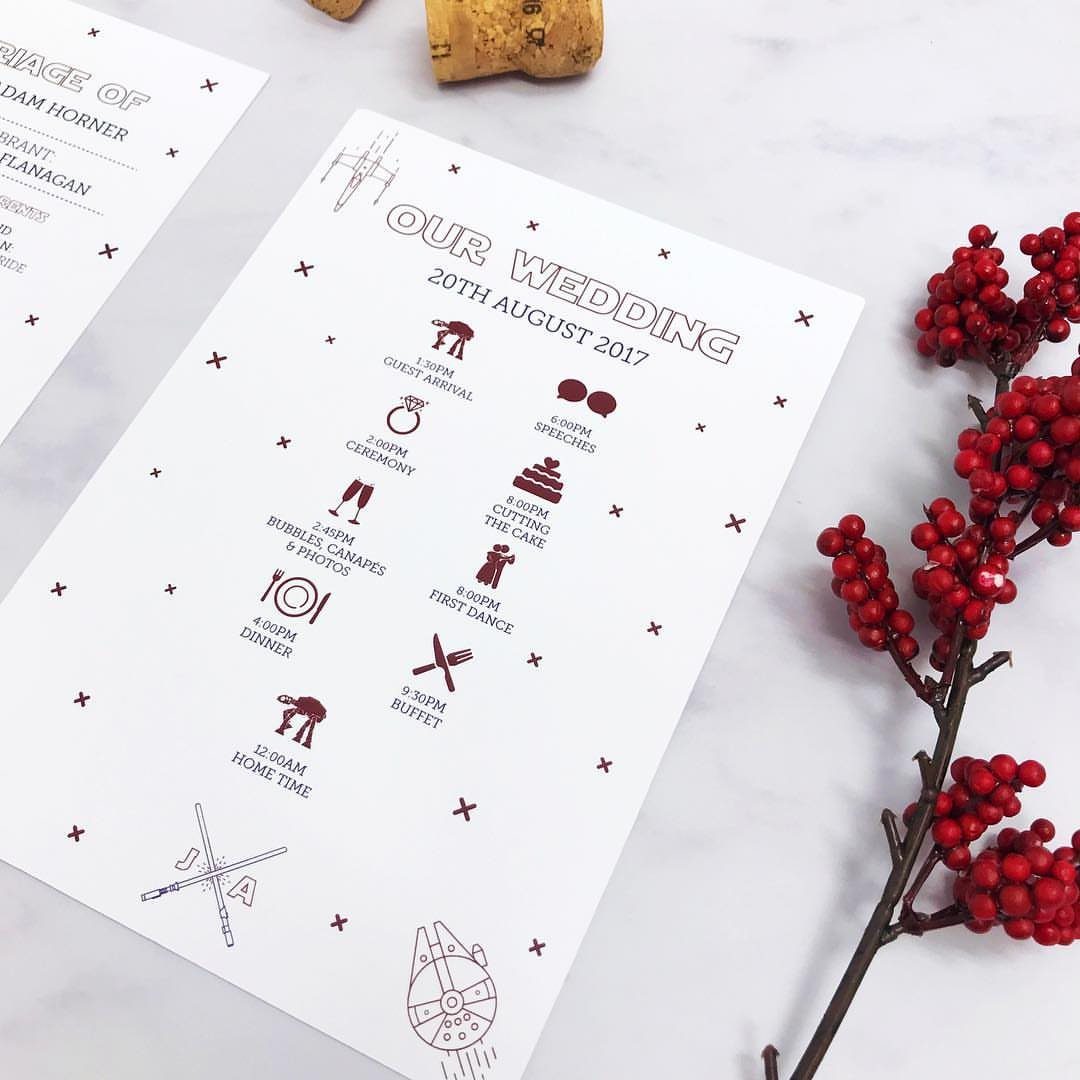 Star Wars themed wedding itinerary card with red icons on a marble surface