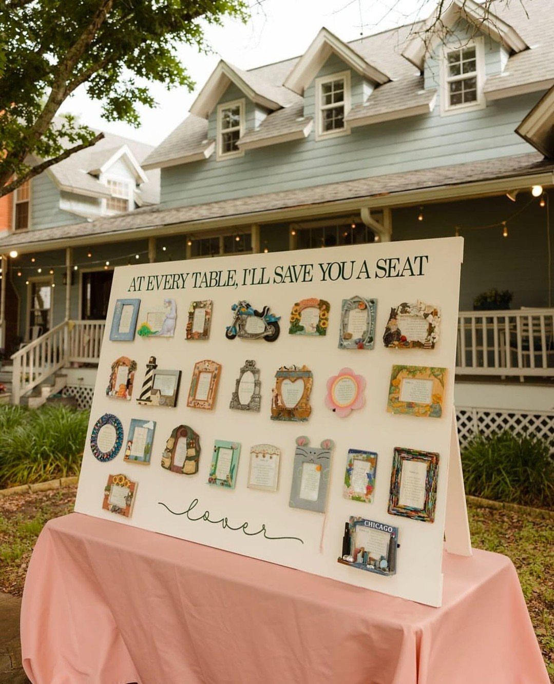 Vintage picture frames on a white board used as a wedding seating chart.