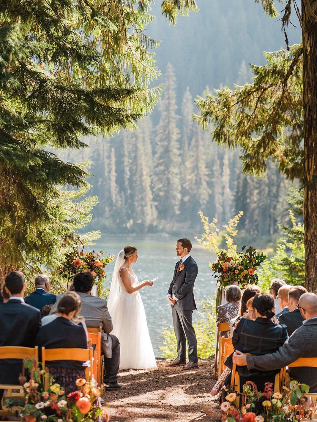 Bride and groom exchanging vows during a wedding ceremony in a pine forest