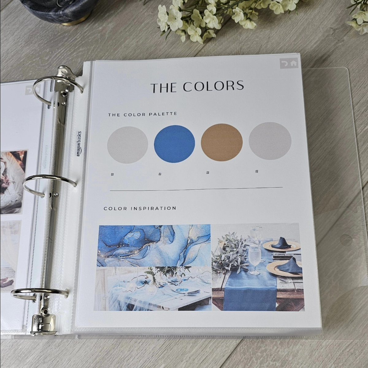 Open wedding binder page showing a blue and gold color palette and inspiration photos.