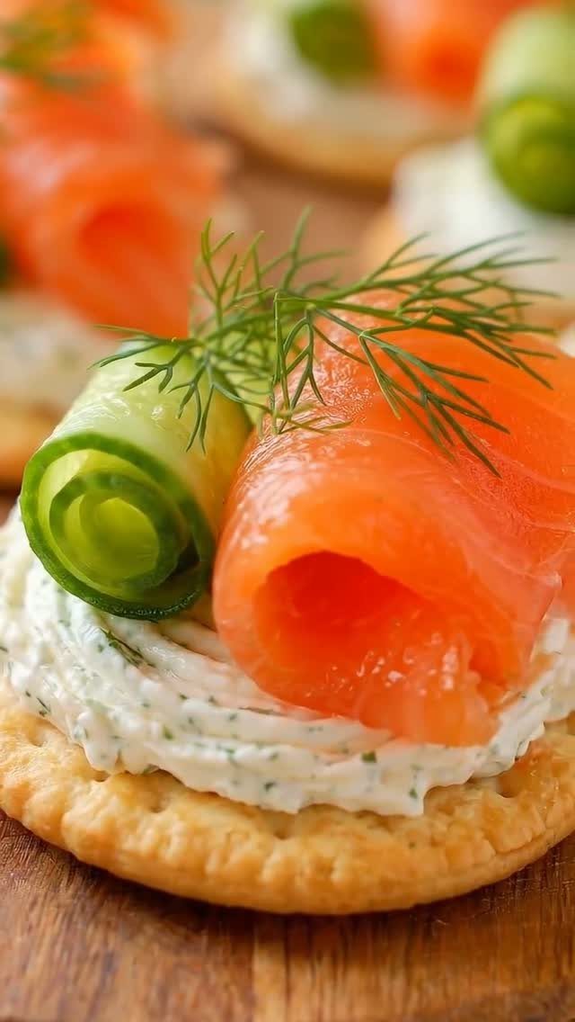 Smoked salmon and cream cheese crackers topped with cucumber and fresh dill.