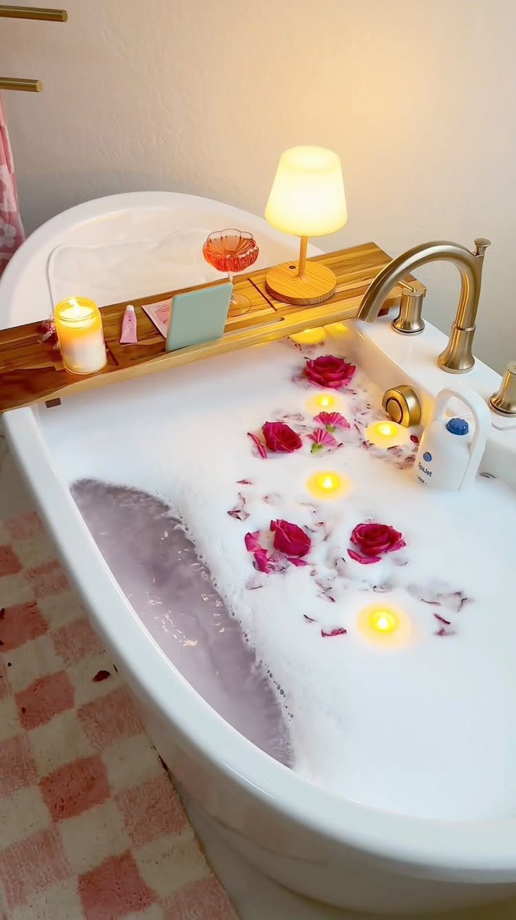 Bathtub with bubbles, red rose petals, and candles for a romantic evening