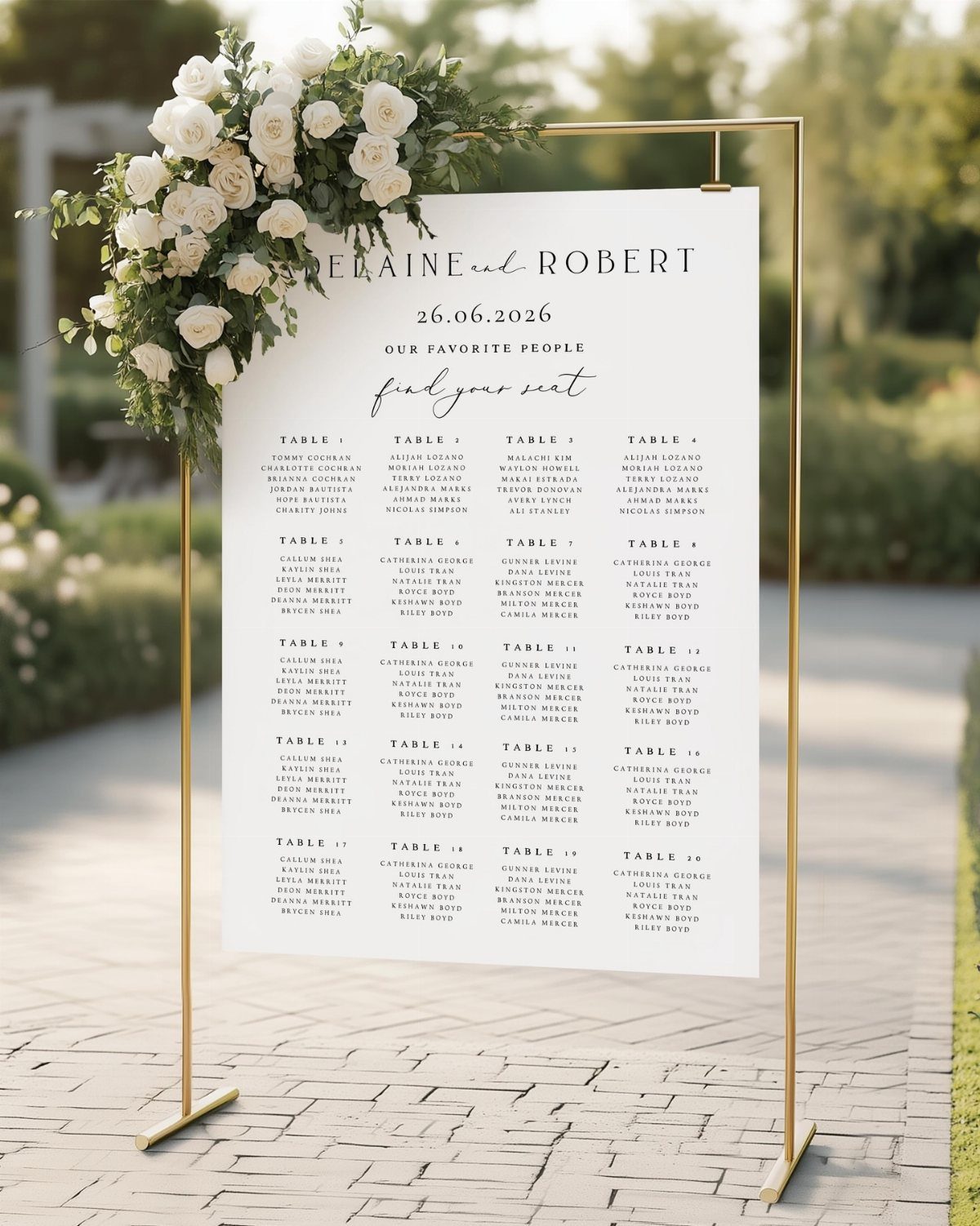 White wedding seating chart on a gold frame decorated with white roses.