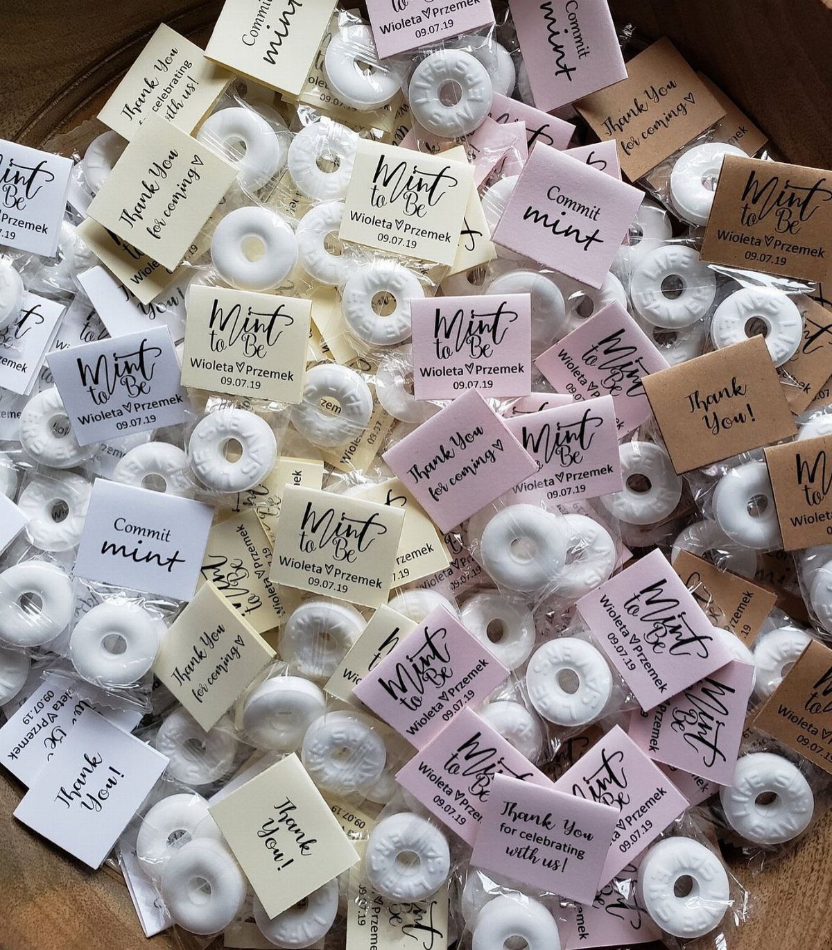 Personalized wedding favor bags with white mints and custom printed thank you tags.
