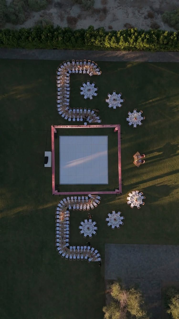 Aerial view of outdoor wedding reception with curved and round dining tables